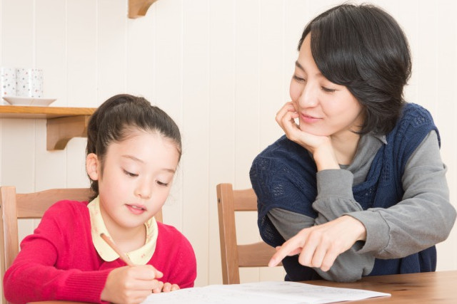 子供に勉強を教える女性